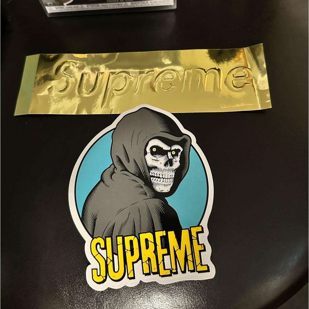 2 Supreme Gold and Great Skelton sticker. Also selling with it, is a New Funko!!